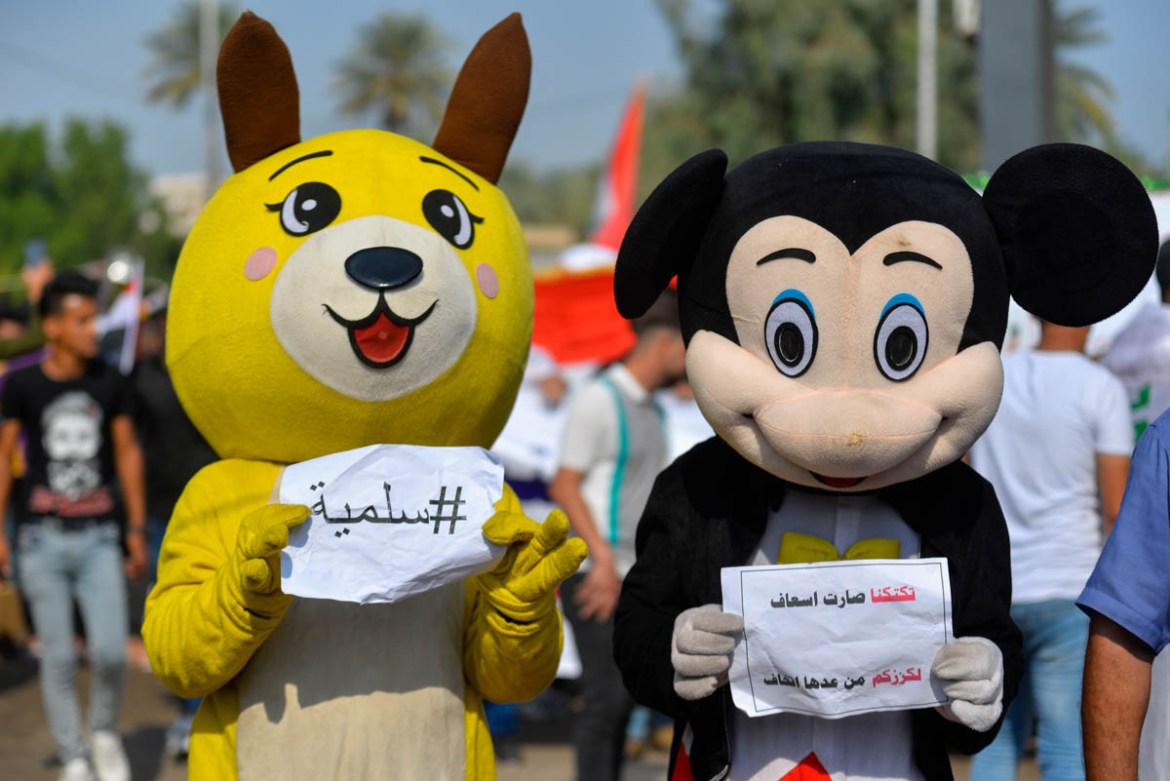 Iraqi protesters dressed as Pikachu and Mickey Mouse take part in ongoing anti-government demonstrations in the southern city of Diwaniyah on November 3, 2019. Protesters in Iraq''s capital and the cou