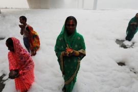 Hindu women worship the Sun god in the polluted waters of the river Yamuna during the Hindu religious festival of Chatth Puja in New Delhi, India, November 3, 2019. REUTERS/Adnan Abidi