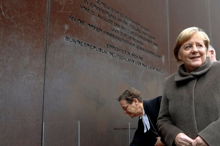 Angela merkal at berlin wall