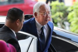 Former Malaysian Prime Minister Najib Razak, right, arrives at Kuala Lumpur High Court, Malaysia in 2019 [File: Vincent Thian/AP]