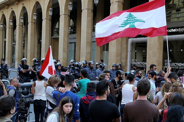 Protesters carry Lebanese flags and shout slogans, in front the entrance of lebanese parliement building during ongoing anti-government protests in downtown in downtown Beirut, Lebanon, 05 November 20