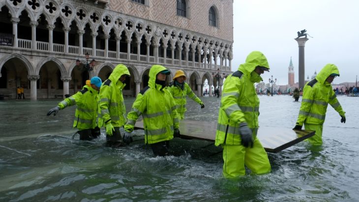Workers are seen in the flooded St.Mark''s Square during a period of seasonal high water in Venice, Italy November 12, 2019. REUTERS/Manuel Silvestri