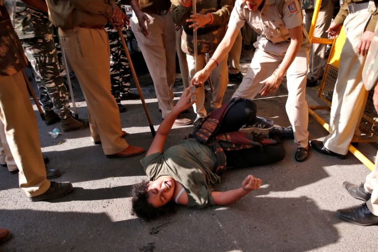 A student of Jawaharlal Nehru University reacts as police try to detain her during a protest against a proposed fee hike, in New Delhi