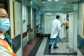 A member of the medical staff enters the Intensive Care Unit at Queen Elizabeth Hospital that treated the university student who fell during a protest in Hong Kong