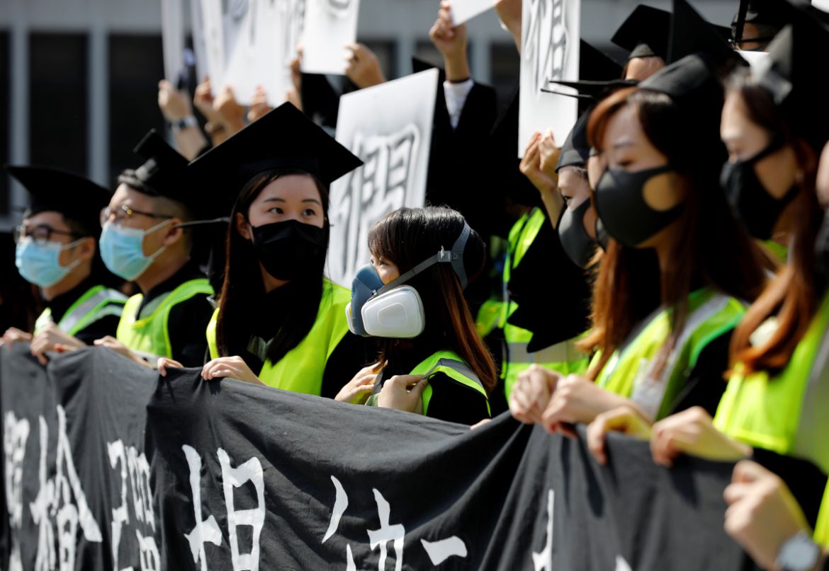 Graduates wearing masks hold an anti-government rally after their graduation ceremony at the Chinese University of Hong Kong in Hong Kong, China, November 7, 2019. REUTERS/Kim Kyung-Hoon