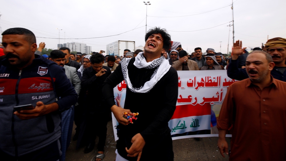 Relative reacts at funeral of demonstrator who was killed at anti-government protest overnight in Najaf