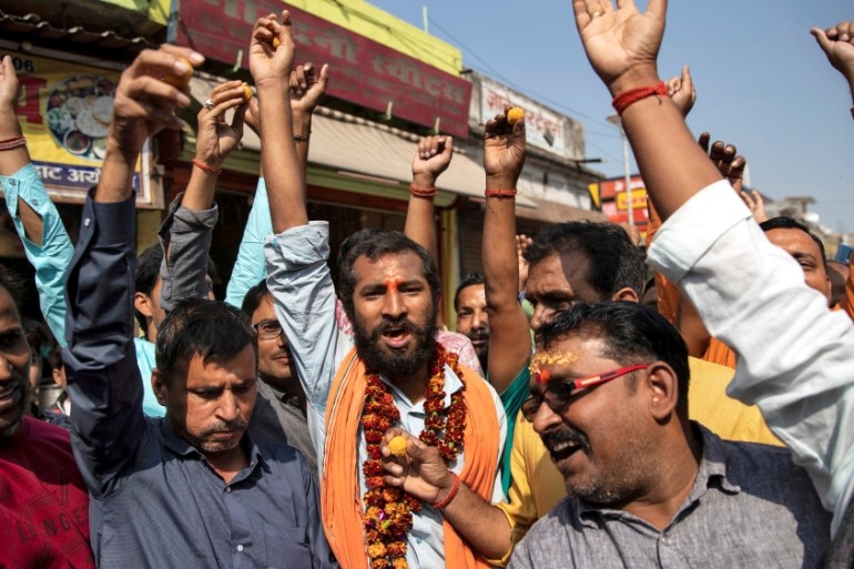 Hindu devotees celebrate after Supreme Court''s verdict on a disputed religious site, in Ayodhya