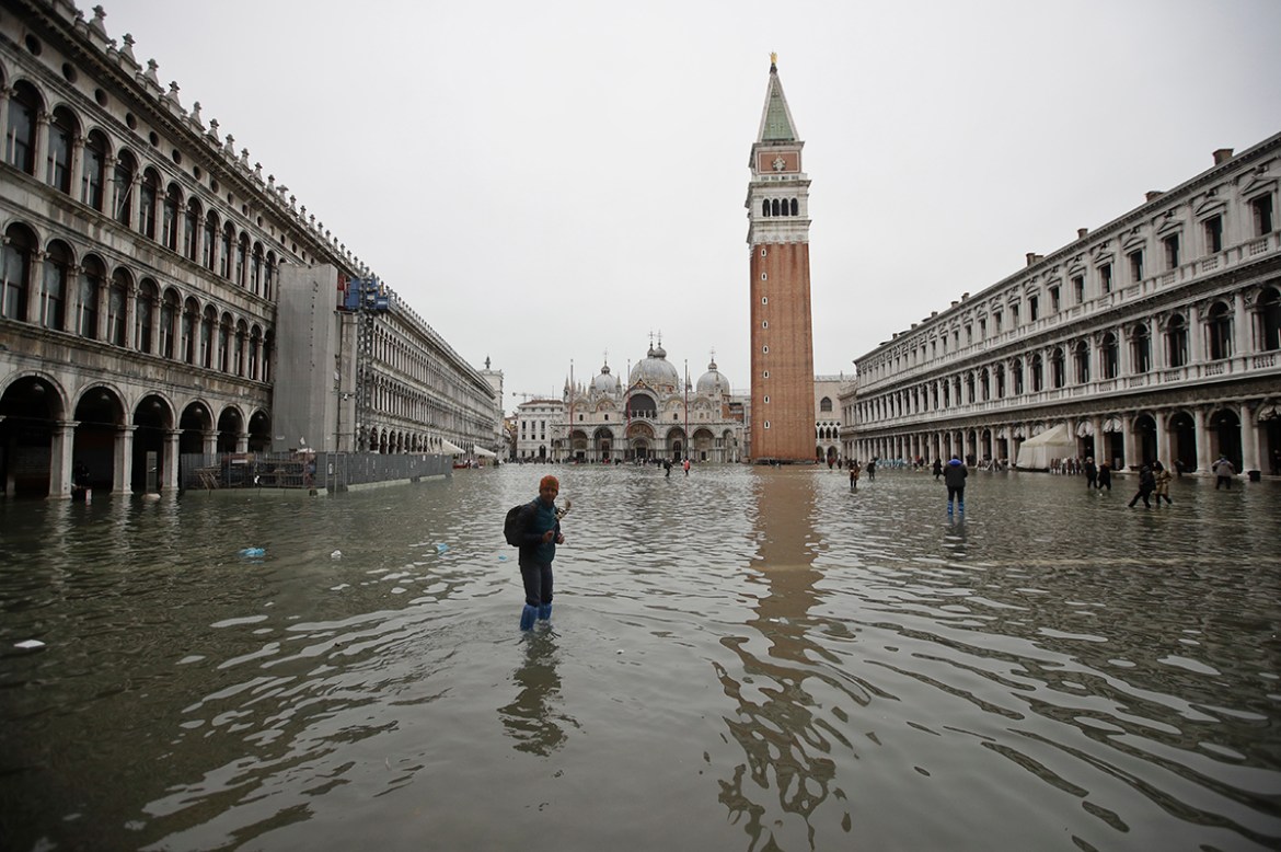 People wade through water in a flooded St. Mark''s Square, in Venice, Wednesday, Nov. 13, 2019. The high-water mark hit 187 centimeters (74 inches) late Tuesday, Nov. 12, 2019, meaning more than 85% of