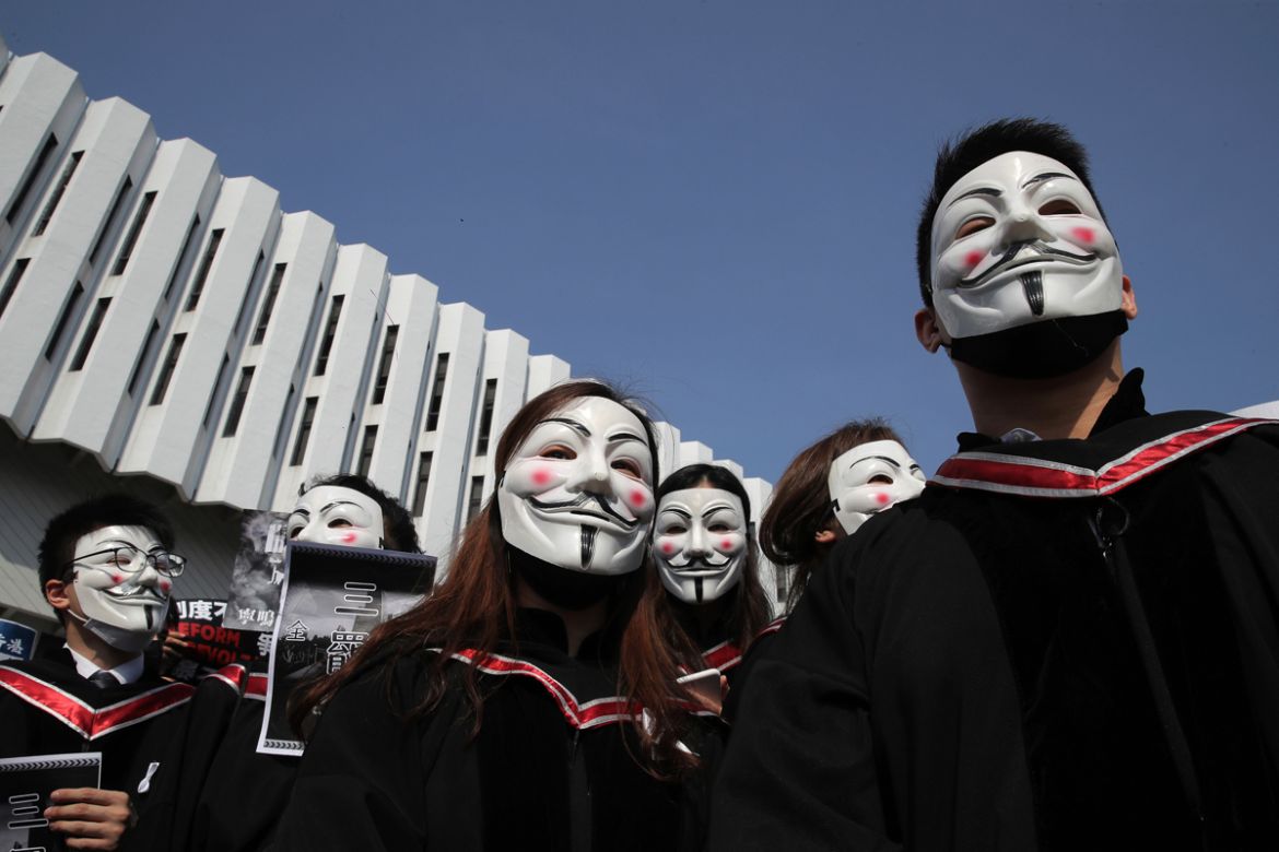 University students wearing Guy Fawkes masks during a protest before their graduation ceremony at the Chinese University of Hong Kong, in Hong Kong, Thursday, Nov. 7, 2019. (AP Photo/Kin Cheung)