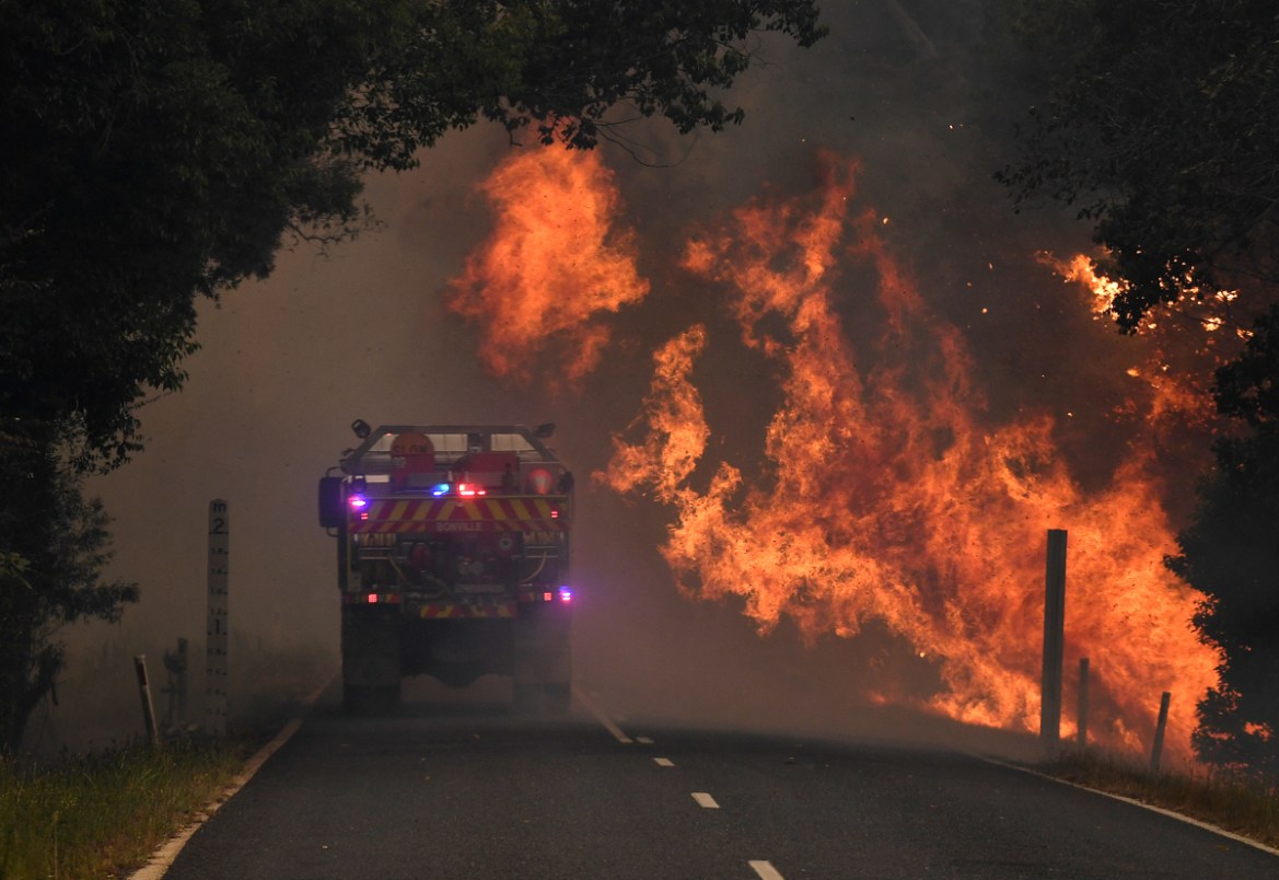 A fire truck is seen near a bushfire in Nana Glen, near Coffs Harbour, Australia, November 12, 2019. AAP Image/Dan Peled/via REUTERS