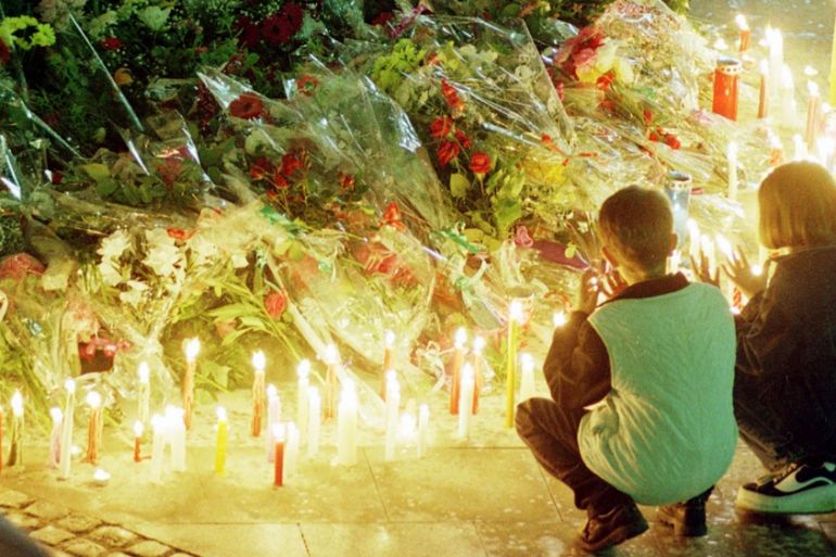Two young citizens of Tuzla say their prayers for the dead at the massacre site in the center of the town Monday, May 25, 1998, on the 3rd anniversary of a massacre