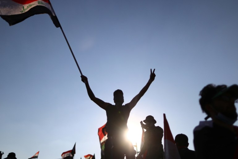 Iraqi demonstrators take part in an ongoing anti-government protest, in Baghdad