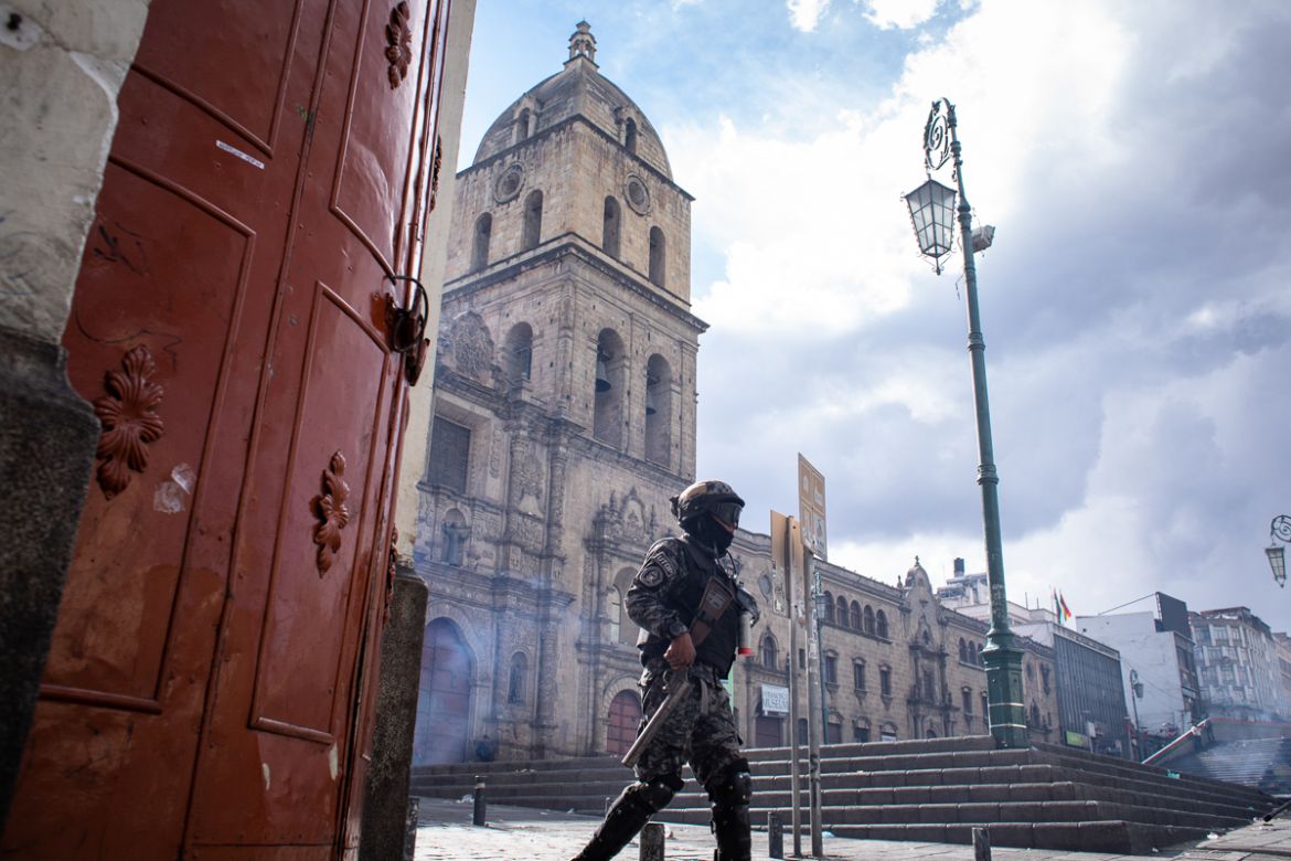 Antiriot police after shooting tear gas to protestors that had been throwing rocks to the police during a demonstration that turned violent in support of the ousted president Evo Morales. Officials st
