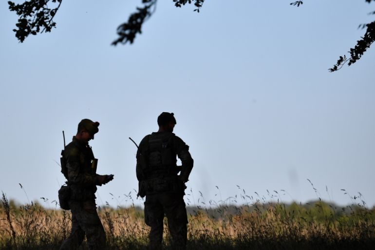 Soldiers await the arrival of Britain''s Prime Minister Boris Johnson on Salisbury plain training area near Salisbury