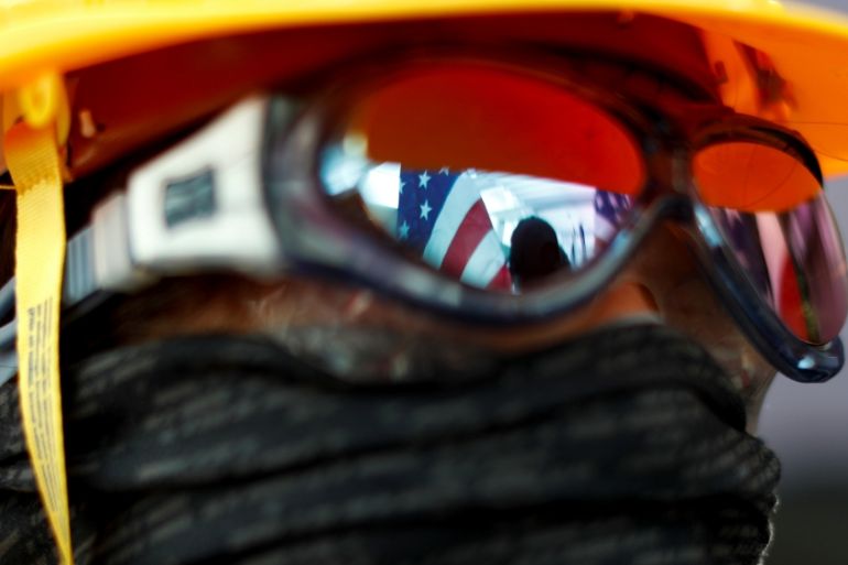 US flags are reflected in an anti-government protester''s sunglasses during a rally at the University of Hong Kong, China September 20, 2019