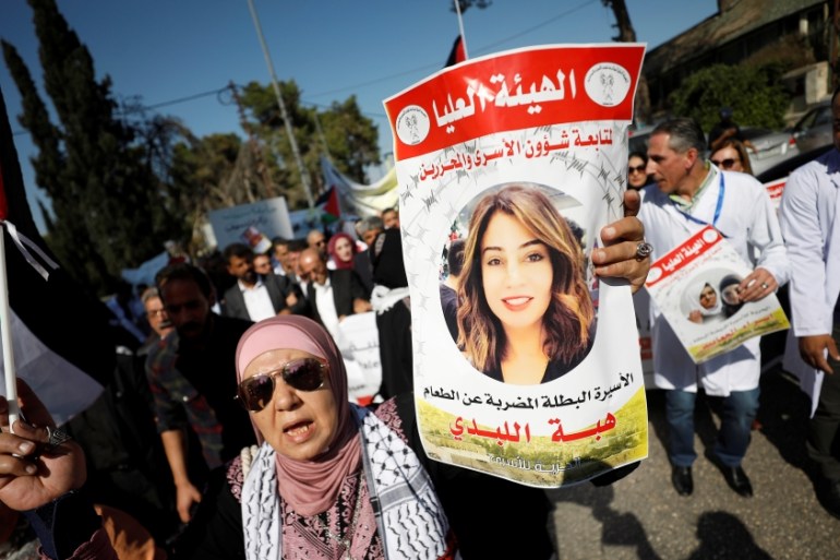 Demonstrator holds a picture of Jordanian citizen Hiba Labadi during a protest in Ramallah in the Israeli-occupied West Bank