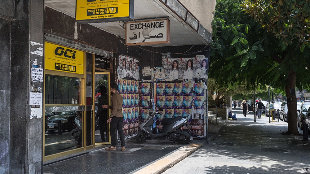 A pedestrian enters a Western Union Co. currency exchange store on Hamra Street in Beirut, Lebanon, on Tuesday, July 24, 2018. 