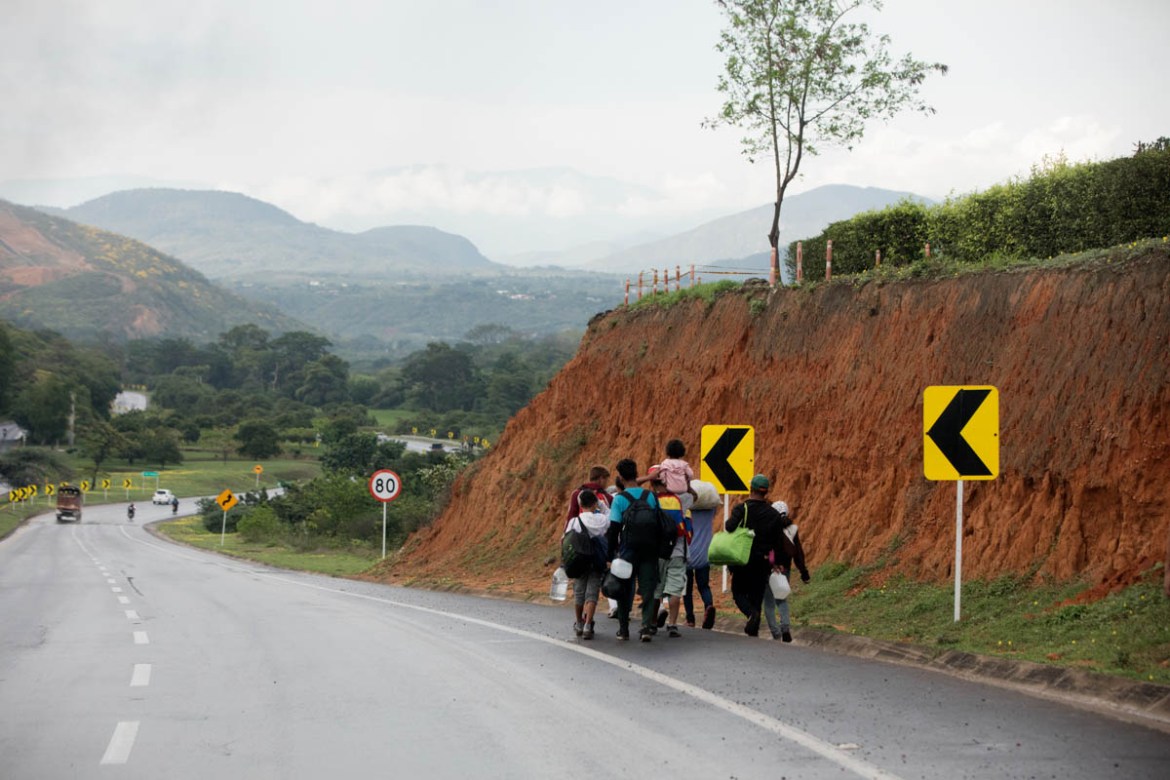 Venezuelans walk along the side of the road from the Colombian border town of Cucuta toward Pamplona, one of the first major cities along the migration route to the capital, Bogota. Healthy and able-b