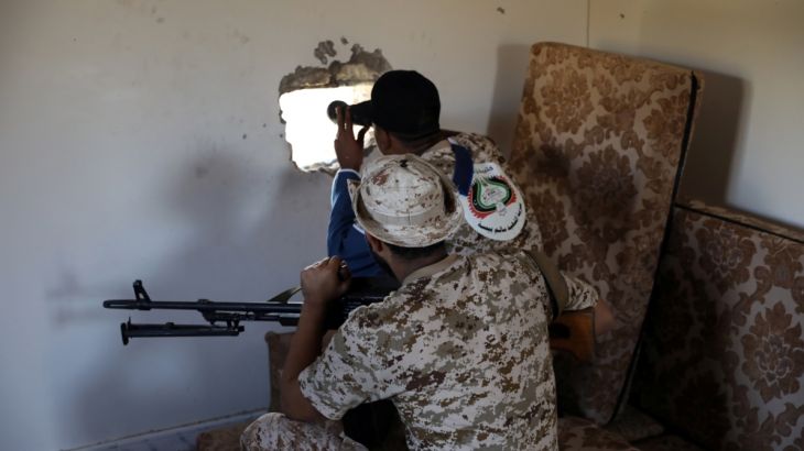 Members of the Libyan internationally recognised government forces take their positions in Ain Zara