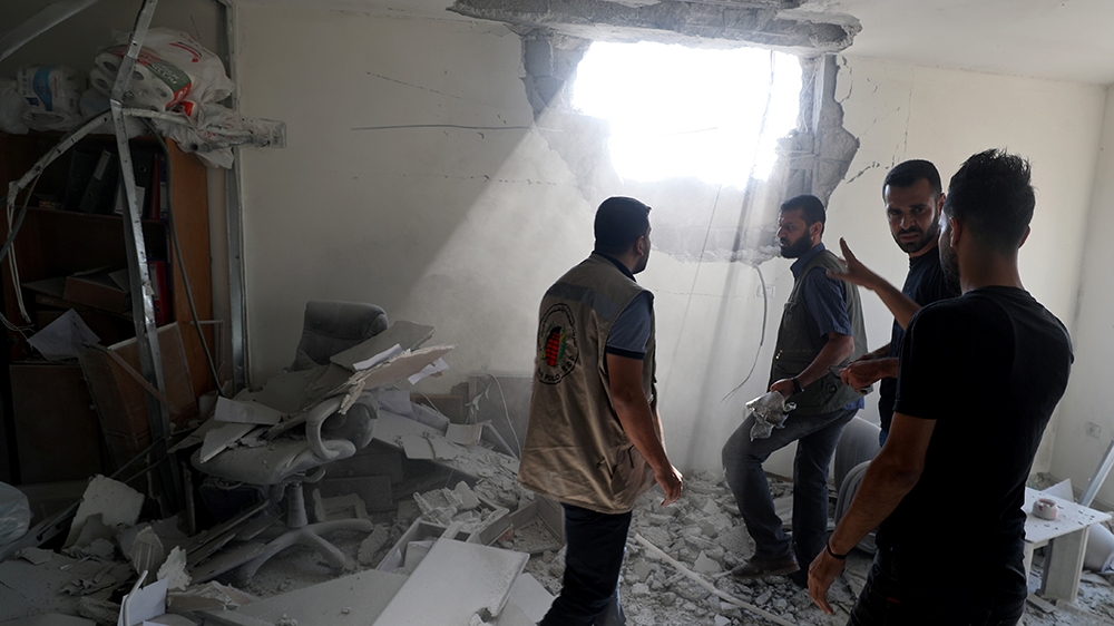 Palestinians inspect a damaged building in Gaza City November 12, 2019. REUTERS/Mohammed Salem