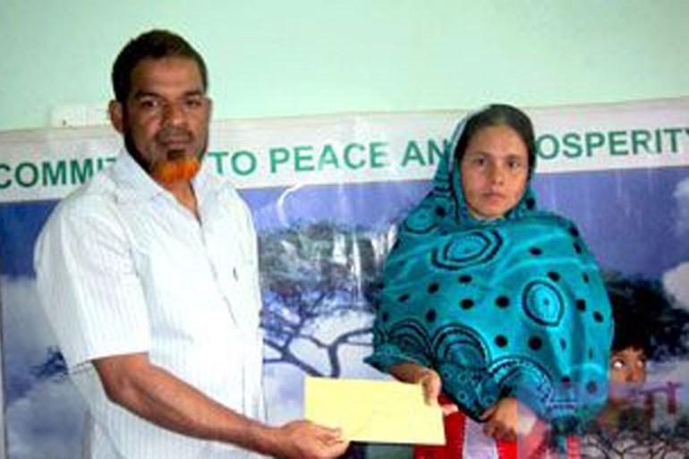 khandaker on left giving on charity