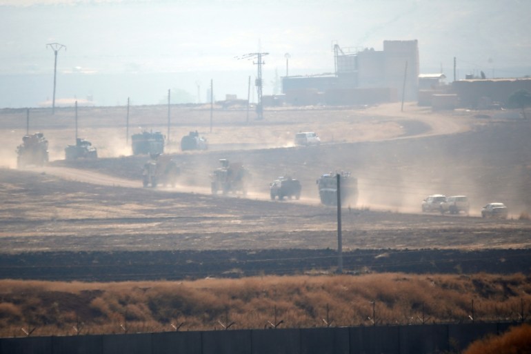 Turkish and Russian military vehicles are seen during a joint patrol in northeast Syria, as they are pictured near the Turkish border town of Kiziltepe