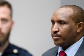 Congolese militia commander Bosco Ntaganda, right, rises as judges enter the courtroom of the International Criminal Court, or ICC, to deliver the sentence in his trial in The Hague, Netherlands, Thur