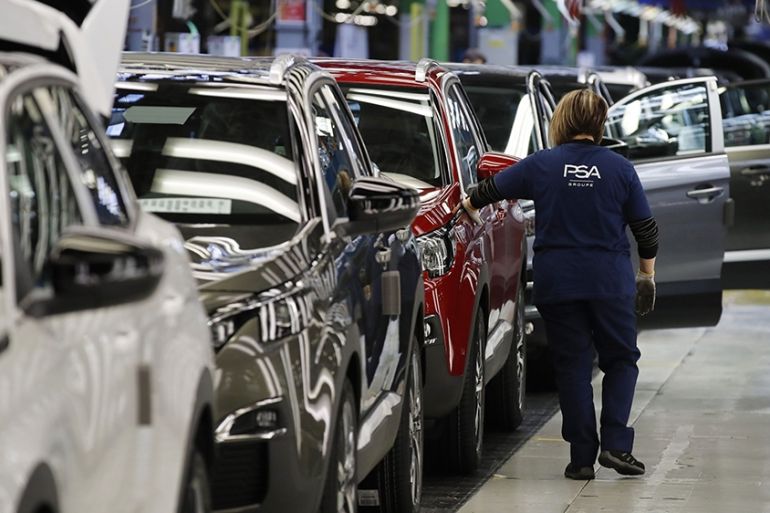 An employee performs a final inspection on Peugeot 3008 compact sports utility vehicles on the assembly line at the Peugeot SA plant, operated by the PSA Group, in Sochaux, France, Friday, April 5,