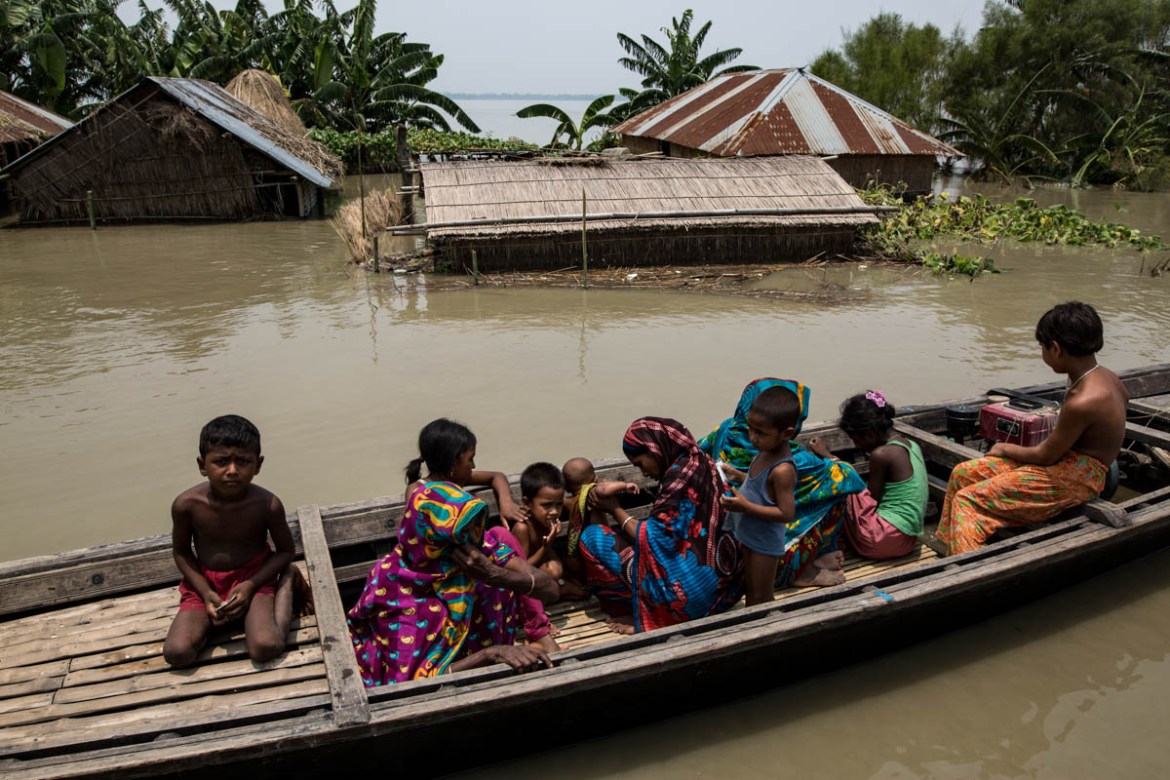 People living on a boat as their houses submerged by water at Ulipur area of Kurigram district in Bangladesh. Around 6.77 lakh hectares of croplands have been damaged by the recent flood that affected