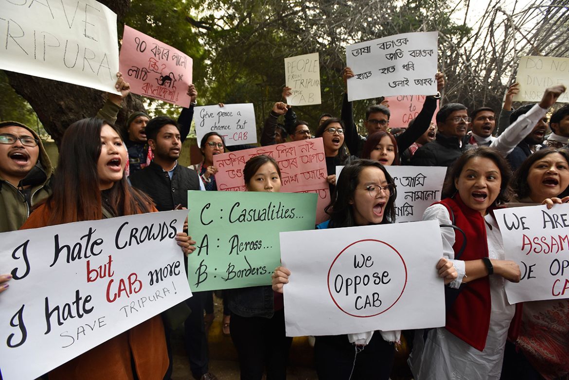 People from the north eastern states raise slogans during a protest against the Citizenship Amendment Bill (CAB), on December 11, 2019 in New Delhi, India. Normal life came to a halt on Tuesday in sev