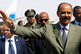 Eritrean President Isaias Afwerki waves upon his arrival for a state visit to Sudan at the Khartoum Airport