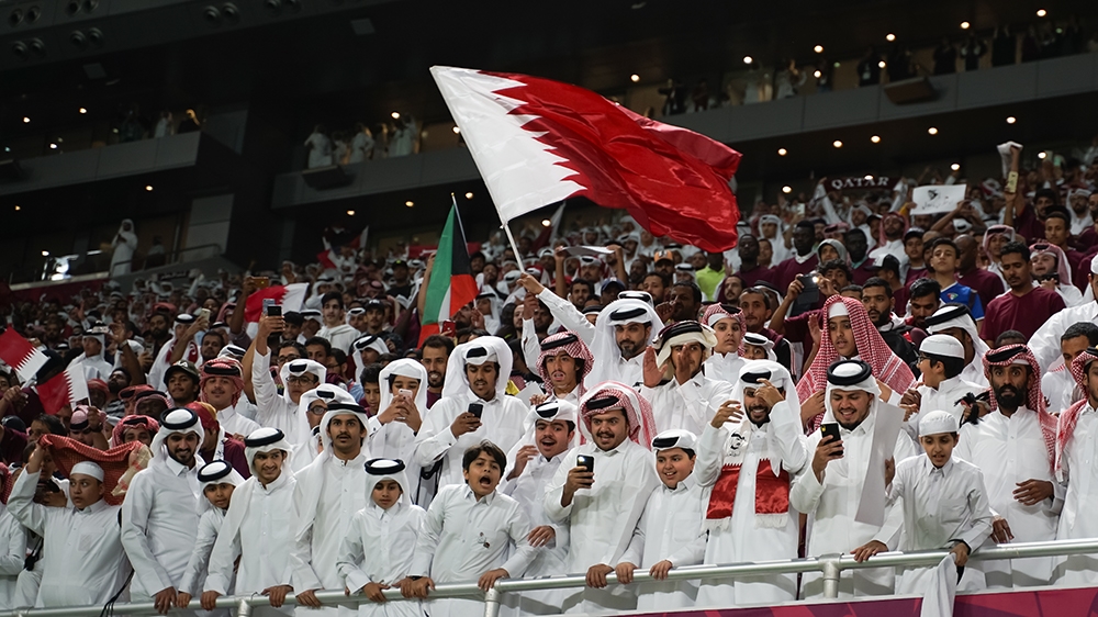 Qatari fans celebrating their team's victory over UAE [Sorin Furcoi/Al Jazeera]