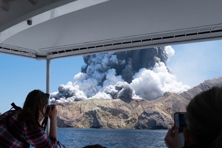 This handout photograph courtesy of Michael Schade shows the volcano on New Zealand''s White Island spewing steam and ash moments after it erupted on December 9, 2019. New Zealand police said at least