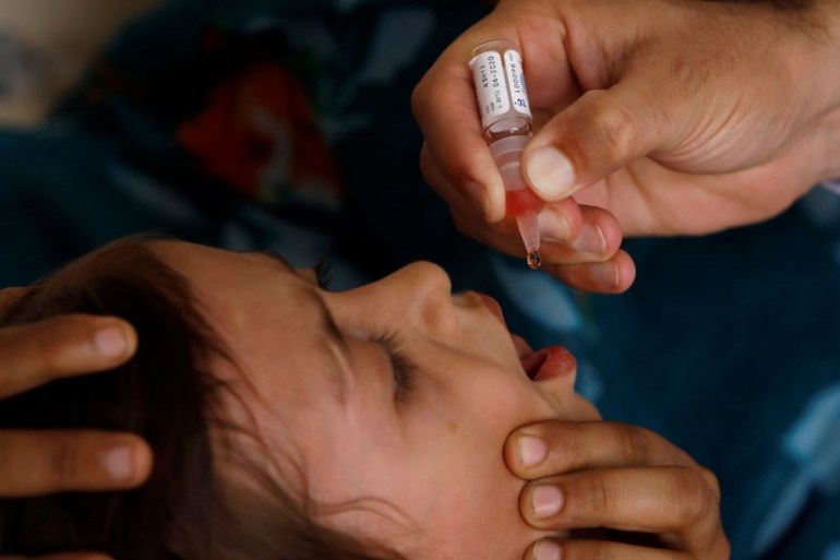 Polio vaccine drops are administered to a child at a civil dispensary in Peshawar