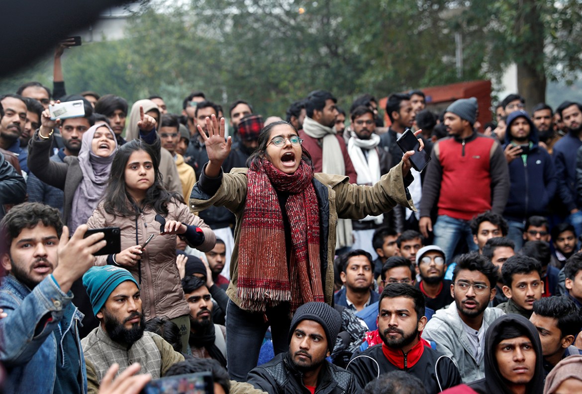 A student of the Jamia Millia Islamia university reacts during a demonstration after police entered the university campus on the previous day, following a protest against a new citizenship law, in New