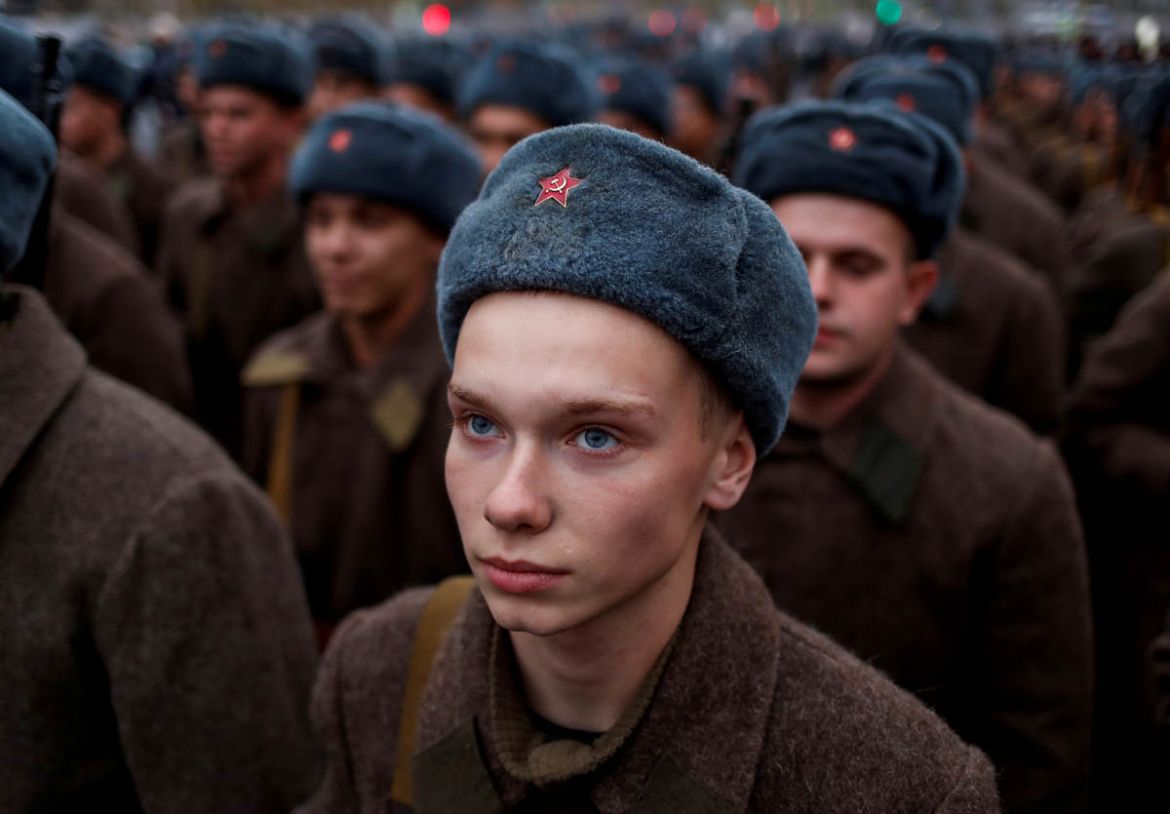 A Russian Army member, dressed in historical uniform, looks on before a rehearsal for a military parade to mark the anniversary of a historical parade in 1941, when Soviet soldiers marched towards the