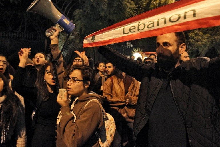 LEBANON-POLITICS-DEMO Protesters chant slogans as they march during a demonstration outside the Interior Ministry headquarters in the Lebanese capital Beirut on December 11, 2019. IBRAHIM AMRO / AFP