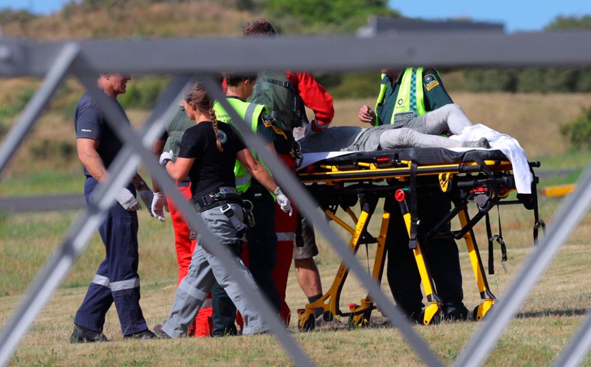 Emergency services attend to an injured person arriving at the Whakatane Airfield after the volcanic eruption Monday, Dec. 9, 2019, on White Island, New Zealand. (Alan Gibson/New Zealand Herald via AP