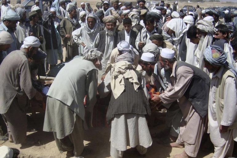 In this photograph taken on September 4, 2009, Afghan mourners prepare to bury victims during a funeral in Kunduz, after an ISAF airstrike on an oil tanker hijacked by Taliban insurgents. More than 10