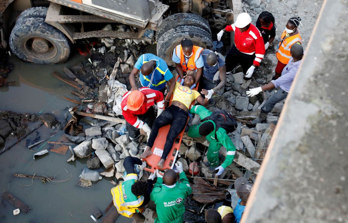 An injured women rescued from the rubble is carried by rescuers at the scene where a building collapsed in Nairobi, Kenya December 6, 2019. REUTERS/Baz Ratner TPX IMAGES OF THE DAY