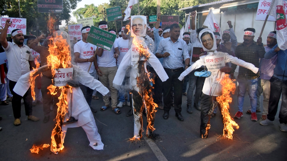 Activists from AASU burn effigies during a protest against the Citizenship Amendment Bill, in Guwahati