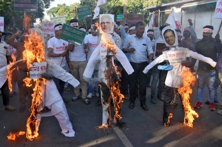 Activists from AASU burn effigies during a protest against the Citizenship Amendment Bill, in Guwahati