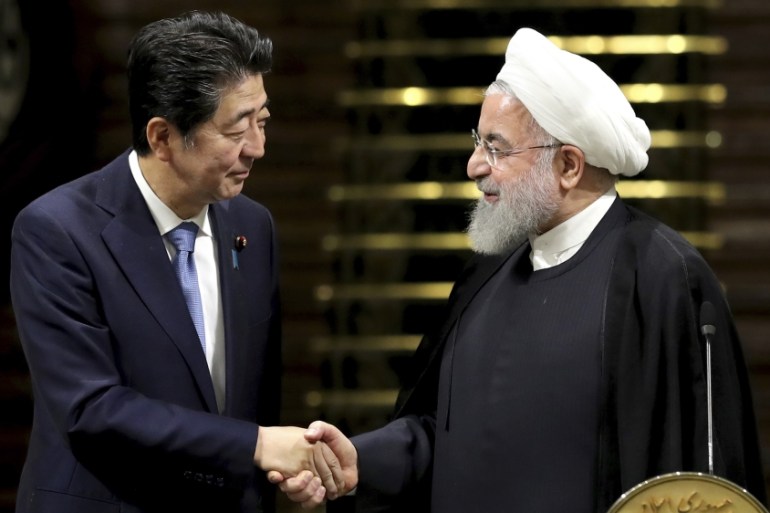 Japanese Prime Minister Shinzo Abe, left, and Iranian President Hassan Rouhani