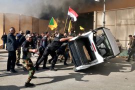 Protesters damage property inside the U.S. embassy compound, in Baghdad, Iraq, Tuesday, Dec 31, 2019. Dozens of angry Iraqi Shiite militia supporters broke into the U.S. Embassy compound in Baghdad on