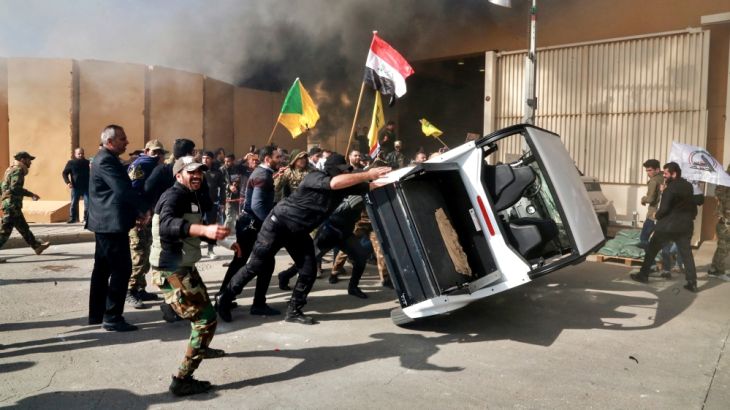 Protesters damage property inside the U.S. embassy compound, in Baghdad, Iraq, Tuesday, Dec 31, 2019. Dozens of angry Iraqi Shiite militia supporters broke into the U.S. Embassy compound in Baghdad on
