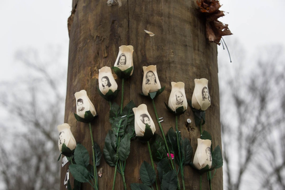 White roses with images of the victims of the tragedy in Sandy Hook on a telegraph pole in the town centre after the mass shootings at Sandy Hook Elementary School, Newtown, Connecticut, USA. 17th Dec