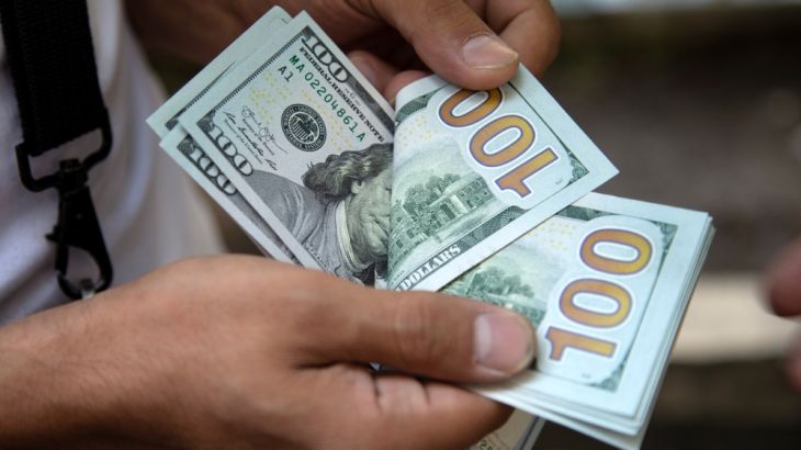 A man counts U.S. dollars in Tehran