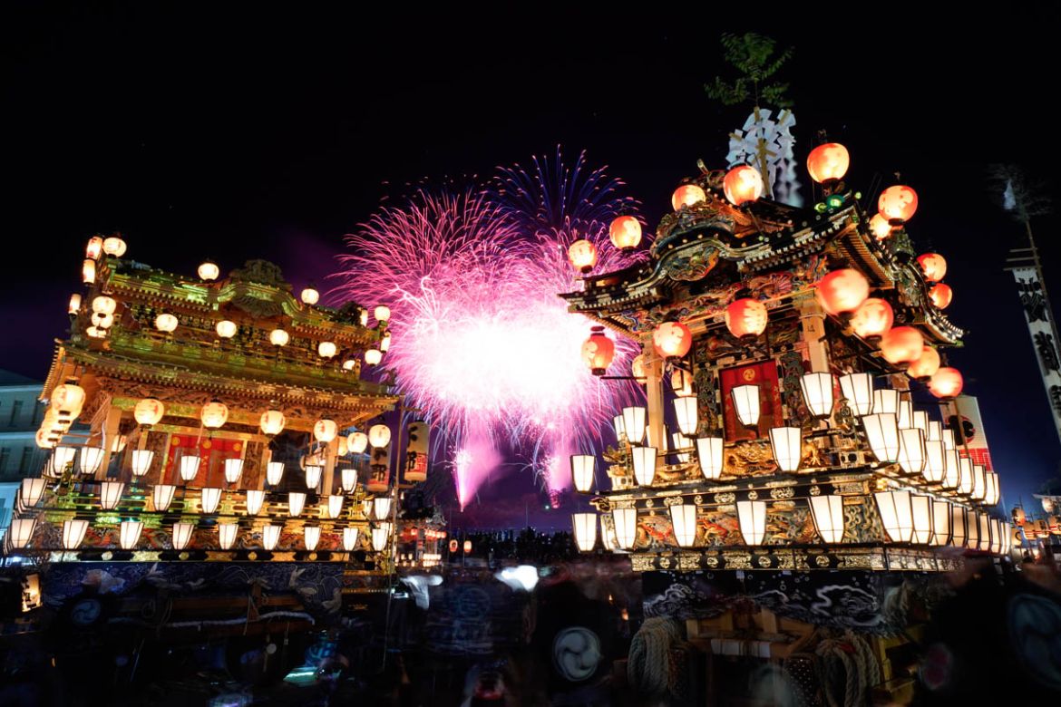 In this Tuesday, Dec. 3, 2019, photo, lantern-covered floats stand as fireworks light up the sky during the Chichibu Night Festival in Chichibu, north of Tokyo, Japan. The Chichibu Night Festival, whi