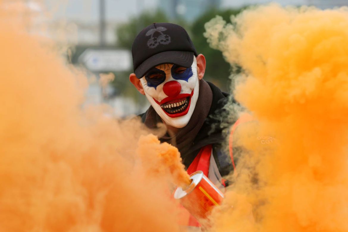 A protester wearing a mask is seen amongst smoke as French Labour unions members demonstrate against French government''s pensions reform plans in Marseille as part of a day of national strike and prot