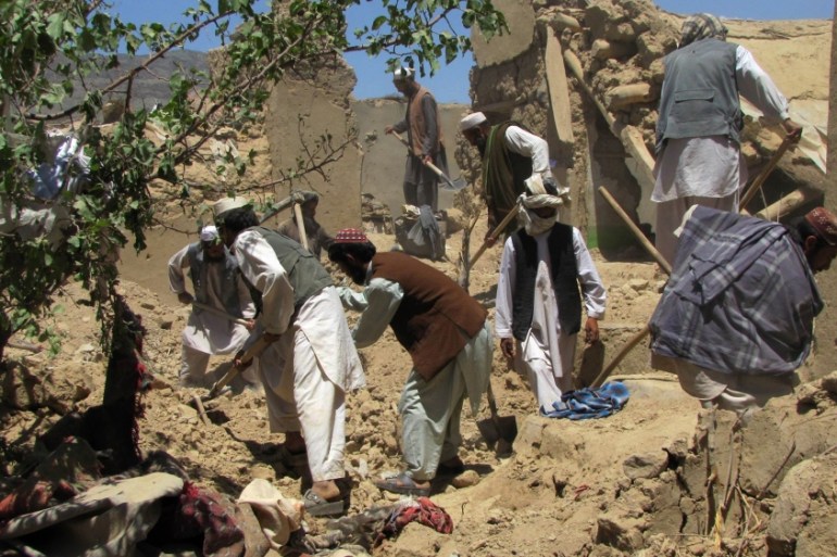 Afghan villagers search for dead bodies of people who were killed in a NATO airstrike on a home in Sajawand village in Logar province, south of Kabul on June 6, 2012. At least 15 civilians, including